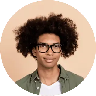 A smiling man with curly hair and glasses in an olive shirt