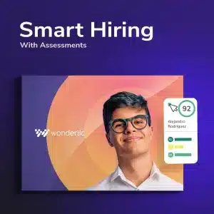 Graphic featuring the text "Smart Hiring With Assessments" and "Wonderlic". A young person in glasses, identified as Alejandro Rodriguez, proudly displays a scorecard with a score of 92. For more information or to get in touch, contact us today. Background boasts a dynamic purple and orange swirl design.