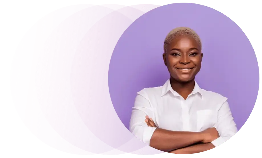 Person with short blond hair wearing a white shirt, smiling with arms crossed. They are in front of a purple background with overlapping pink circles on the left side.